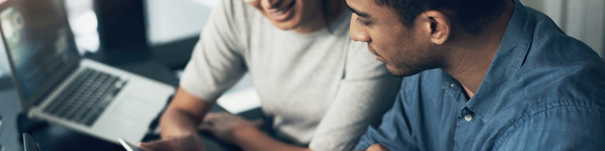 shot-of-two-young-workers-using-a-digital-tablet-in-a-modern-office.jpg